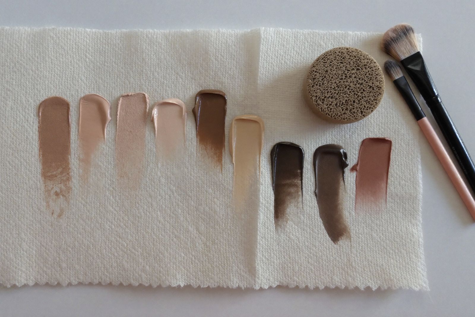 Foundation swatches from porcelain to espresso on cream paper